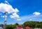 Shiny steel smokestack and cloud in sky