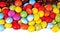 Shiny sugar coated round chocolate balls as background. Candy bonbons multicolored texture. Round candies sweets pattern