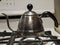 A shiny tea kettle on a stove