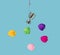 A shiny trophy on fish hook surrounded by hearts in different colors. Blue water background