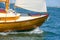 Shiny varnished wooden sailboat bow sailing