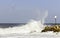 Ship on a background of the waves breaking about a breakwater