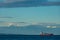 Ship in bay of Thessaloniki in anchorage. While snowcapped summit of Olympus Mountain on background, Greece
