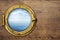 Ship or boat porthole on wooden wall