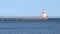 Ship channel at Wisconsin Point in superior with sailboat and lighthouse.