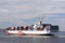 Ship with colorful containers near new york with blue sky on sun