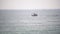 A ship crosses the Bay in a calm sea. Azure ocean and blue sky merge on the horizon