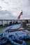 Ship deck view with United States flag and blue mooring rope.