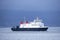 Ship ferry at sea under dark blue storm sky in bad weather