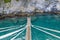 Ship gangway and rocky seashore. Blue sea