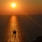 The ship and its shadow in the rays/lights of the setting sun/sunrise, Santorini Greece.