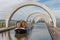 Ship leaves the Falkirk Wheel, rotating boat lift in Scotland,