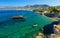 Ship like pirate schooners with two masts for sails near rocks of the coast of Crete