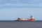 Ship on the ocean horizon. Profile of industrial supply vessel