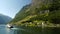 Ship Passing Beautiful Small Town in the Fjords of Norway