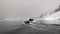 Ship and people in rubber boat on background of ice in ocean of Antarctica.
