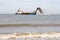 Ship pumping sand onto beach for coastal defense