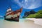 ship ran aground on deserted tropical beach with crystal-clear water