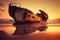 ship ran aground and half-sunken on a sandy beach in the sunset