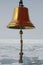 Ship`s bell on a background of icy sea