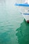 Ship\\\'s bow and aquamarine water in the port of Syracuse, Sicily. Boat and sea, detail. Sailing vessel drops anchor in