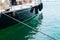 Ship\\\'s bow and aquamarine water in the port of Syracuse, Sicily. Boat and sea, detail. Sailing vessel drops anchor