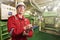 Ship`s mechanic near marine diesel generators on a merchant ship in the engine room