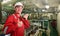 Ship`s mechanic near marine diesel generators on a merchant ship in the engine room