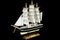 Ship Sailboat Wooden Model on a Black Background