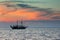 Ship sailing against colorful sky after sunset over the sea