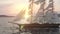 Ship sailing in rough seas close up on sunset background