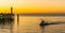 Ship sailing on the sea at the harbor of Blankenberge, Belgium, the pier with lighthouse, beautiful colorful sky at sunset