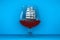 Ship with sails inside a glass of wine