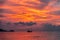 Ship in the sea against the backdrop of a fiery sunset sky