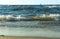 Ship in the sea on the horizon, Sea waves on the beach, a storm in the Baltic sea