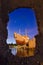 Ship on shore in night harbor - stone frame