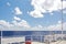 Ship structures, masts, antennas, funnel, ship wheelhouse against the blue sky and clouds.