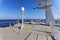 Ship structures, masts, antennas, funnel, ship wheelhouse against the blue sky and clouds.