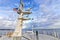 Ship structures, masts, antennas, funnel, ship wheelhouse against the blue sky and clouds.