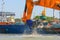 Ship with working excavator is dredging the port