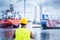 Shipbuilding engineer checking documents at the dockside in a port.