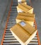 Shipment boxes sorting on rollers conveyor belt at distribution warehouse.