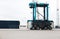 Shipping, cargo and logistics with straddle carrier for container, delivery and transportation at port. Freight, export