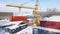 Shipping container and cargo crane at storage yard at winter time aerial view