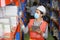 Shipping industry workers wearing facial mask and safety vest working in warehouse checking for the inventory using digital tablet