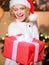 Shipping parcels. Courier delivery service. Christmas bucket list. Girl Santa hat hold gift box. Delivery services. Send