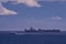 Shipping traffic in Juan de Fuca Strait. a container ship at anchor is passed by a catamaran filled with passengers for Seattle