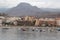 Ships in the coast, cityscape and mountain.