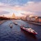 Ships on the Moscow River. View from the soaring bridge of the park `Zaryadye` to the skyscraper on Kotelnicheskaya embankment.