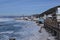 ships, port, mountains, iridescent crystals white blue ice with cracks shine in the light the sun,shore of lake Baikal